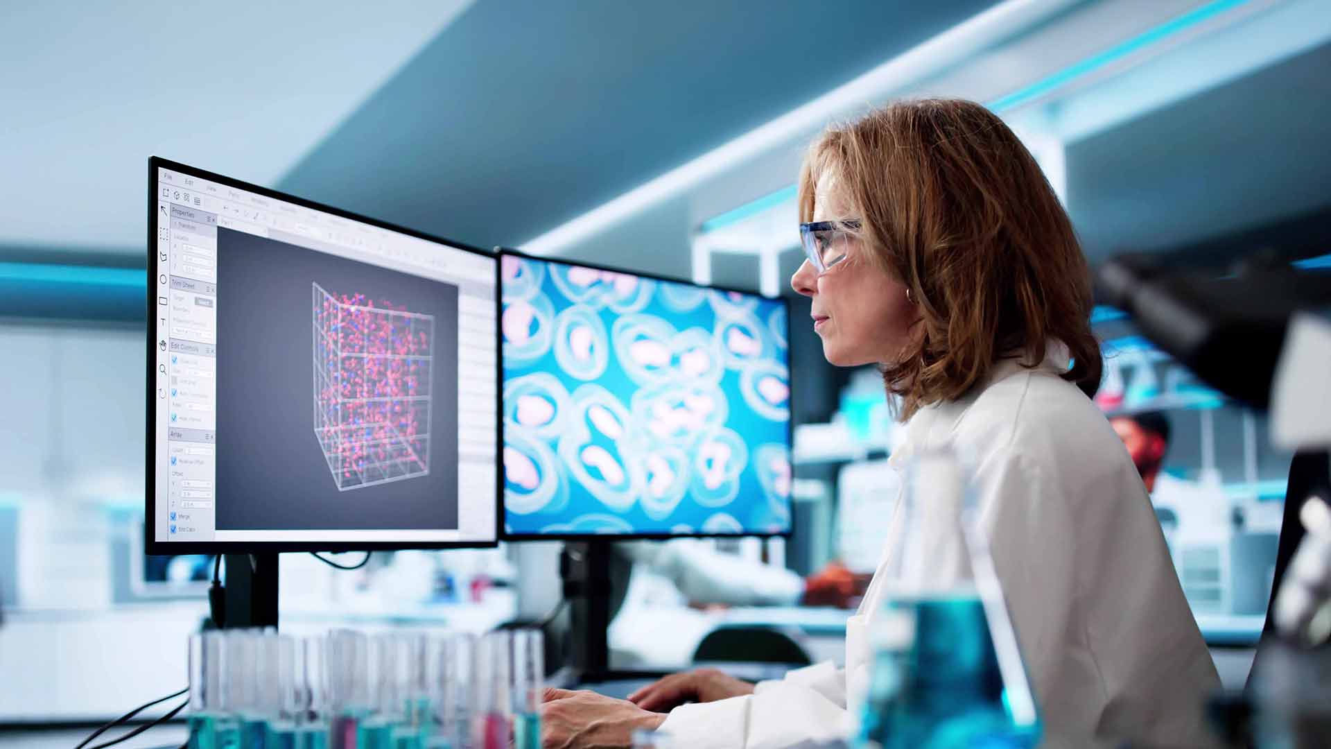 A BMS colleague working at a computer, utilizing AI for research and innovation.