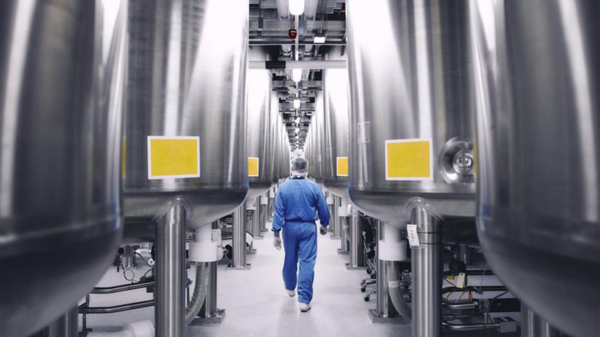 employee walking in manufacturing room,employee walking in manufacturing room