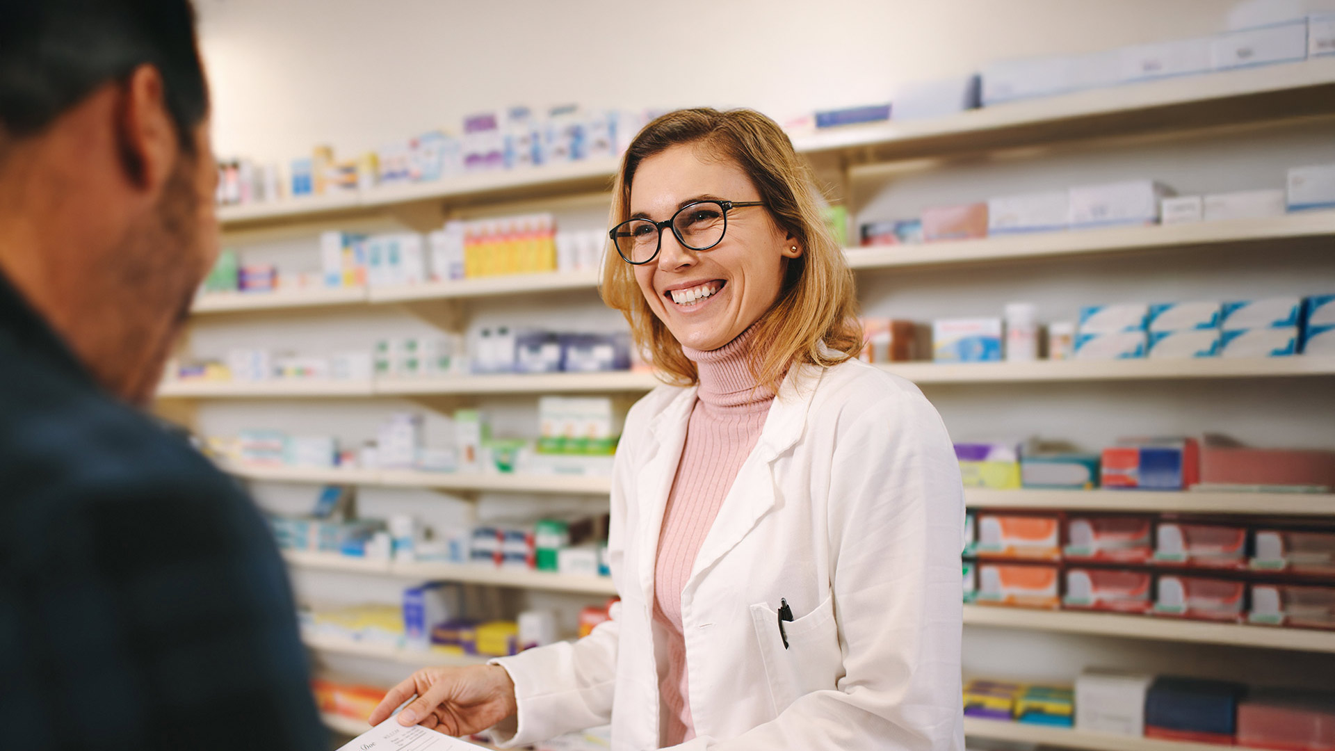pharmacist with customer at counter