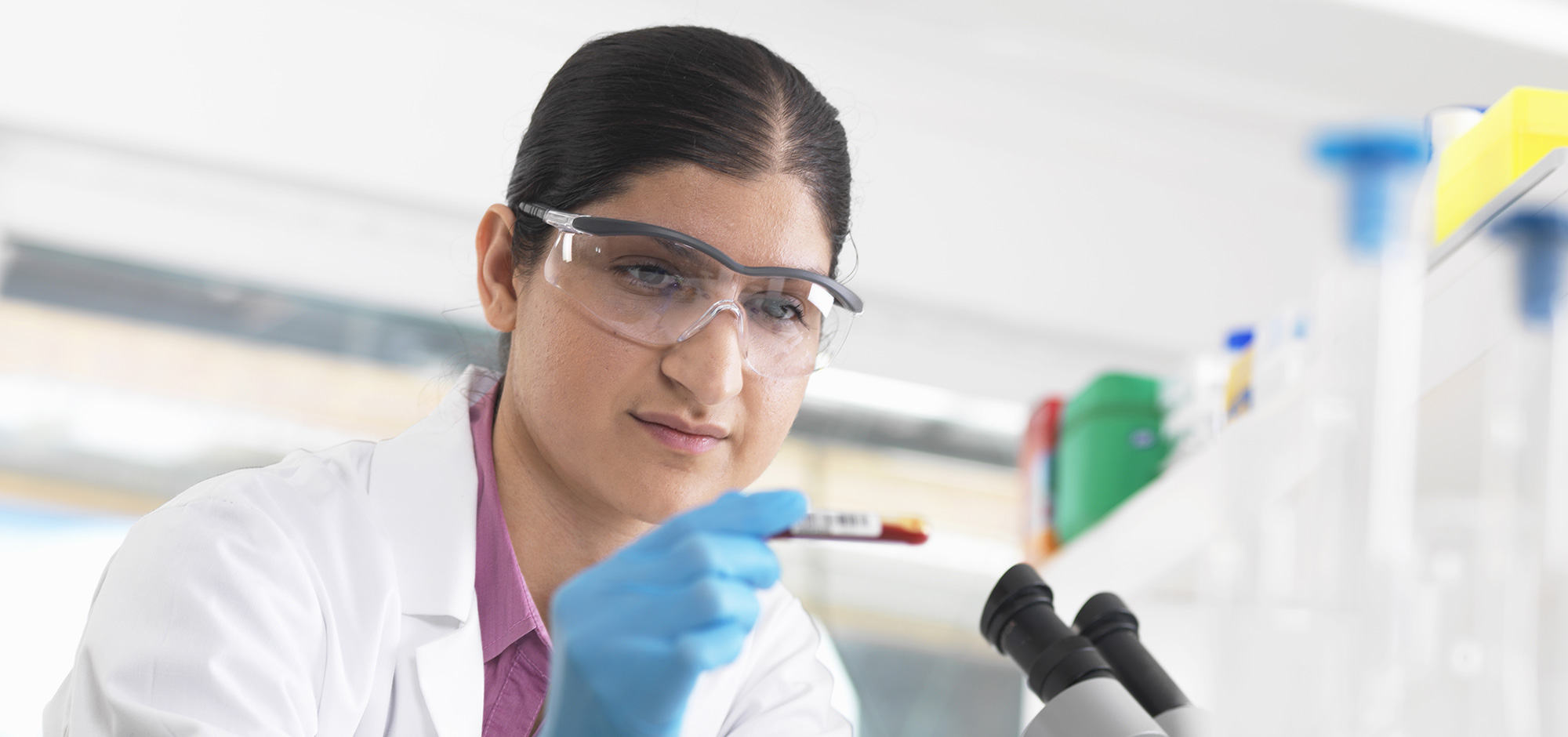 Female scientist in a lab recording findings,Female scientist in lab recording details